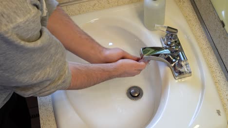 High-angle-of-a-person-demonstrating-the-modern-hand-washing-routine