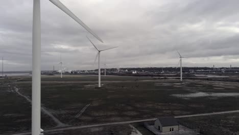 Sustainable-electrical-wind-turbines-spinning-on-England-farmland
