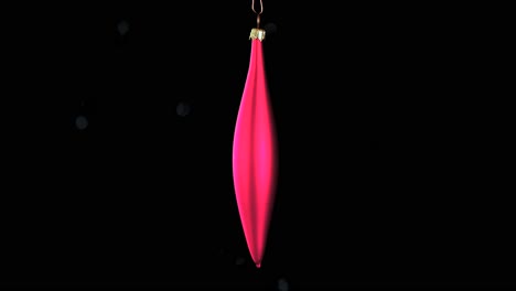 single-red-Christmas-cone-ornament-with-black-background,-close-up