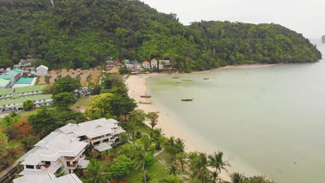 fly-over-seaside-resorts-and-pristine-beach-in-Phuket