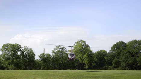Wide-shot-of-helicopter-taking-off-in-middle-of-field