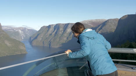 A-Woman-Takes-in-an-Impressive-View-of-Mountains-and-a-Fjord-from-the-Stegastein-Viewing-Platform-in-Norway