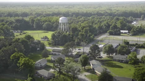 Aerial-view-of-small-town-and-water-tower-from-helicopter