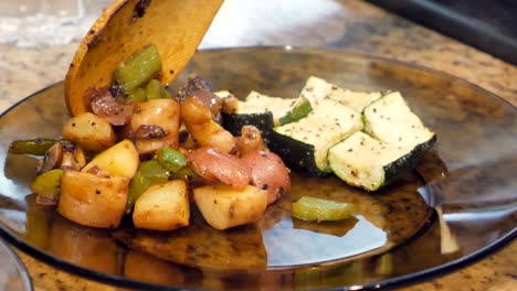 Roasted-potatoes-and-mixed-vegetables-served-on-glass-plate