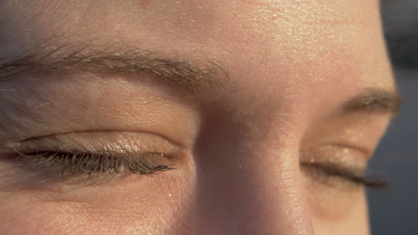 Close-Up-of-a-Relaxed-Woman-Closing-Her-Eyes-in-Slow-Motion-with-Golden-Sunset-Lighting