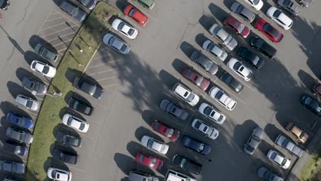 Aerial-View-Of-A-Grey-Car-Passing-On-A-Parking-Lot---Aerial-Shot