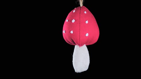 single-crochet-mushroom-Christmas-ornament-with-black-background,-close-up
