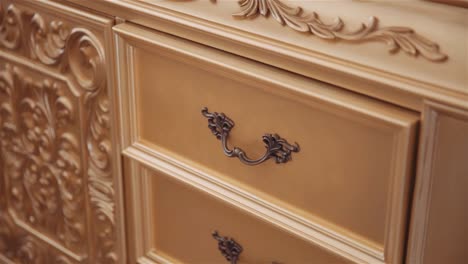 Woman-placing-cloth-in-elegant-drawer-and-pushing-it-to-close