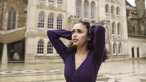 Young-Indian-woman-in-despair-going-through-her-hair-looking-in-the-sky-very-sad-empty-gothic-location-slowmotion