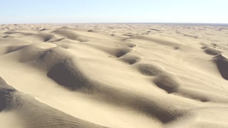 All-terrain-vehicle-ATV-tracks-on-sand-dunes-in-vast-desert,-aerial-view