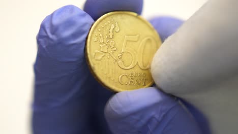 Isolated-close-shot-of-front-fifty-cent-euro-coin-wiped,-corruption-concept