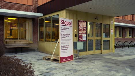 A-partly-closed-hospital-in-Sweden-with-a-big-STOP-sign-telling-you-not-to-enter-if-you-suspect-that-you-are,-or-might-be-infected