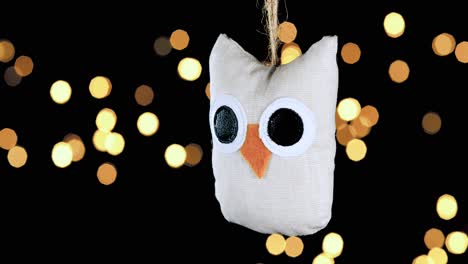 single-crochet-owl-Christmas-ornament-with-out-of-focus-lights-flickering-in-the-background,-close-up