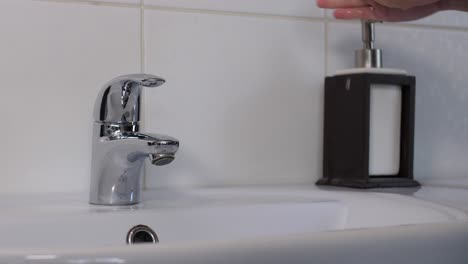 Washing-female-hands-throughly-with-soap,-medium-shot