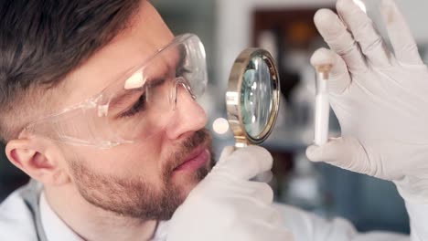 male-scientist-doctor-looks-at-a-blanket-with-a-magnifying-glass
