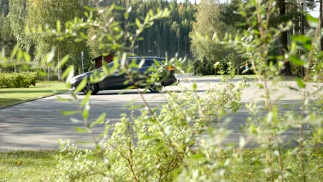 A-car-arriving-at-a-cemetery-in-Sweden-on-a-sunny-day
