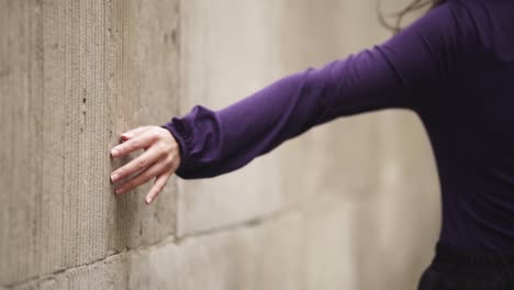 Close-up-of-female-hand-walking-touching-the-wall-in-windy-weather-slowmotion