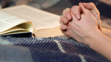 Holy-Bible-with-joined-praying-hands-to-be-saved-from-coronavirus