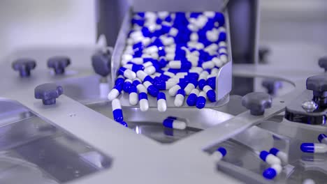 Pills-for-Coronavirus-treatment-falling-into-a-spinning-plate-during-its-mass-production