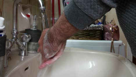 Man-in-quarantine-washing-his-hands-in-a-sink
