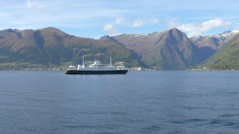 A-Ferry-Passing-Through-a-Fjord-with-Beautiful-Mountains-in-the-Background,-Wide-Slow-Motion