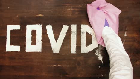 Time-lapse:-Covid-19-letters-sprayed-and-removed-with-pink-wipe