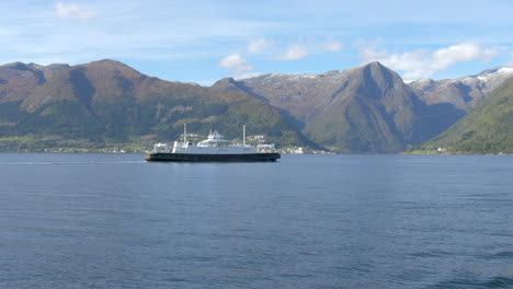 A-Ferry-Passing-Through-a-Fjord-with-Beautiful-Mountains-in-the-Background,-Wide-Shot
