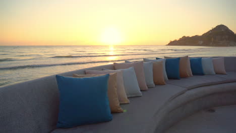 Beautiful-golden-seaside-sunset-view-from-comfortable-beach-lounge-sofa