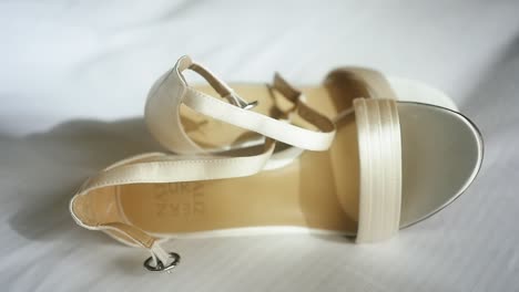 Pretty-off-white-wedding-shoes-on-white-linen-sheets