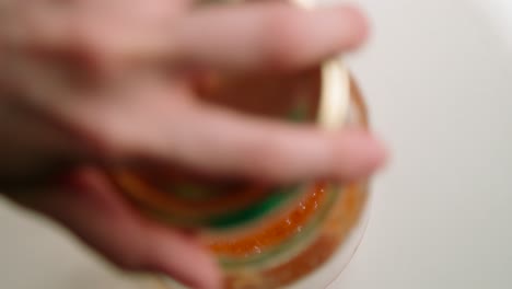 Close-Up-Of-Men's-Hands-Unscrew-The-Jar-Of-Orange-Covered-With-Mold
