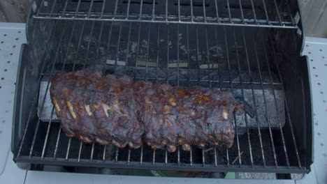 High-angle-shot-of-delicious-spareribs-being-grilled-on-barbecue