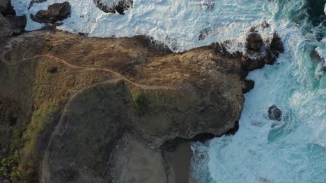Rocky-Shoreline-Birds-Eye-Aerial-View-With-Waves-Crashing-into-Shore