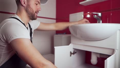 the-plumber-in-working-form-shows-a-thumbs-up-that-everything-will-be-done