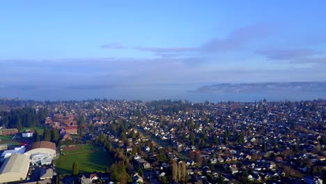 Scenic-View-Of-Lush-Green-Trees-And-Beautiful-Houses-At-The-Tacoma-Neighborhood-Near-Commencement-Bay-In-Washington,-USA-On-A-Sunny-Day---Aerial-Shot