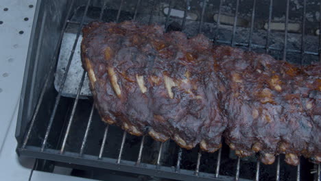 High-angle-shot-of-delicious-spareribs-being-grilled-on-barbecue---close