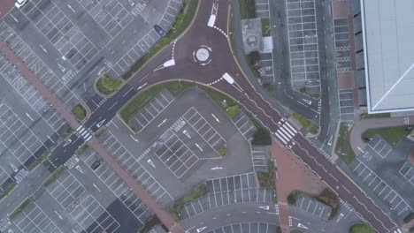 Aerial-view-above-empty-quarantine-corona-virus-outbreak-shopping-retail-car-park-markings-moving-downwards
