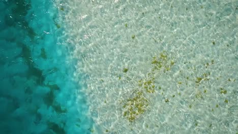 Drone-video-flying-low-over-a-clear-Caribbean-sea,-in-Los-Roques,-Venezuela