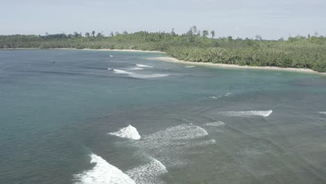 Aerial-flight-above-breaking-waves-in-tropic-Indonesian-bay
