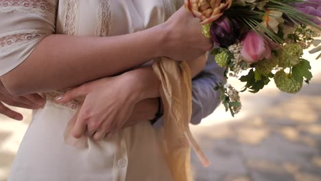 Young-newlyweds-embracing,-holding-hands-and-tickling,-closeup-slow-motion-shot