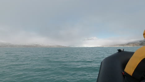 Low-Angle-POV-Shot-of-a-RIB-Boat-Speeding-Across-a-Bright-Blue-Glacial-Lake
