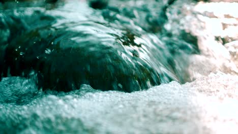 Close-shot-of-flowing-water-in-a-mountain-stream