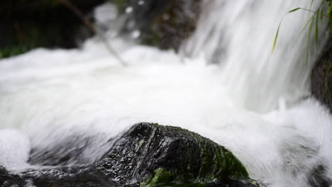 Fuß-Eines-Wasserfalls-Mit-Dem-Weißen,-Frischen-Wasser,-Das-über-Die-Felsen-In-Den-Bach-Darunter-Strömt