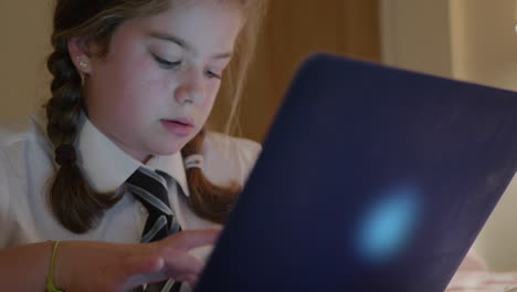 A-young-schoolgirl-does-her-homework-on-a-laptop