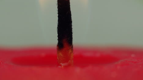 Time-lapse:-macro-studio-view-of-hot-melting-wax-falling-down-on-hot-wick