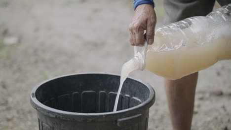 Man-Pouring-Raw-Coconut-Liquour-To-Container