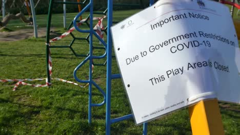 Public-warning-covid-corona-virus-public-warning-park-playground-lock-down-closed-tape-blowing-in-breeze