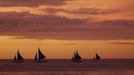 Slow-Panning-Shot-Of-Boracay-Beach-With-Sail-Boats-During-Sunset