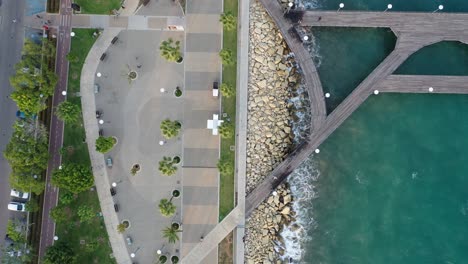 Bird's-eye-view-over-the-tropical-boardwalk-on-the-coast-of-Limassol,-Cyprus
