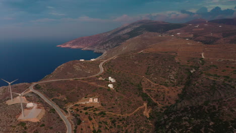Aerial-shot-of-a-cycladic-island-landscape-with-two-wind-turbines