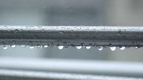 Close-Up-Shot-Of-Laundry-Pole-On-The-Balcony-With-Rain-Drops-During-Rainy-Day-In-Tokyo,-Japan